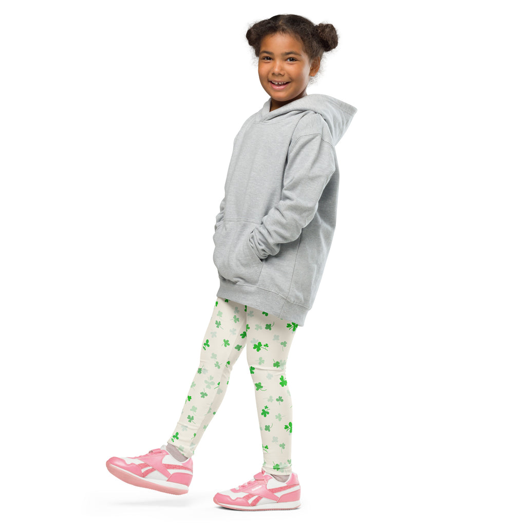 A young girl wearing girls shamrock buttery soft light gray hooded sweatshirt and matching green shamrock leggings