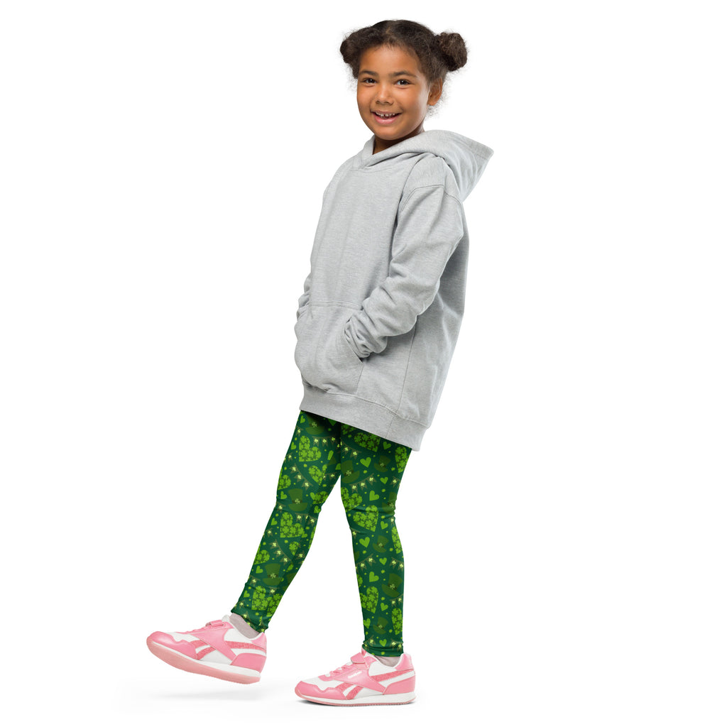 A child wearing green shamrock buttery soft leggings and a light gray hooded sweatshirt front view