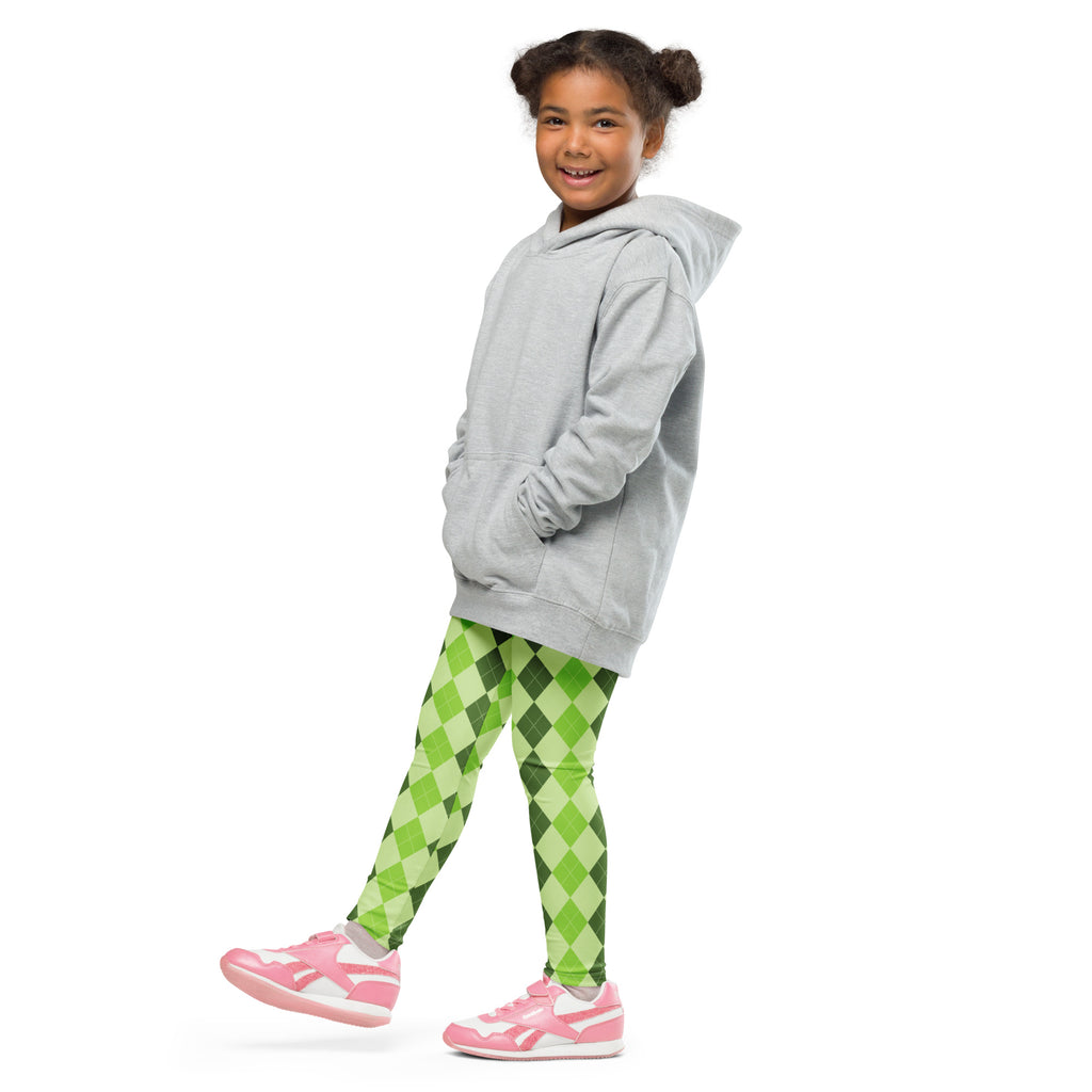 A child wearing girls light green argyle buttery soft leggings paired with a gray hooded sweatshirt and pink sneakers