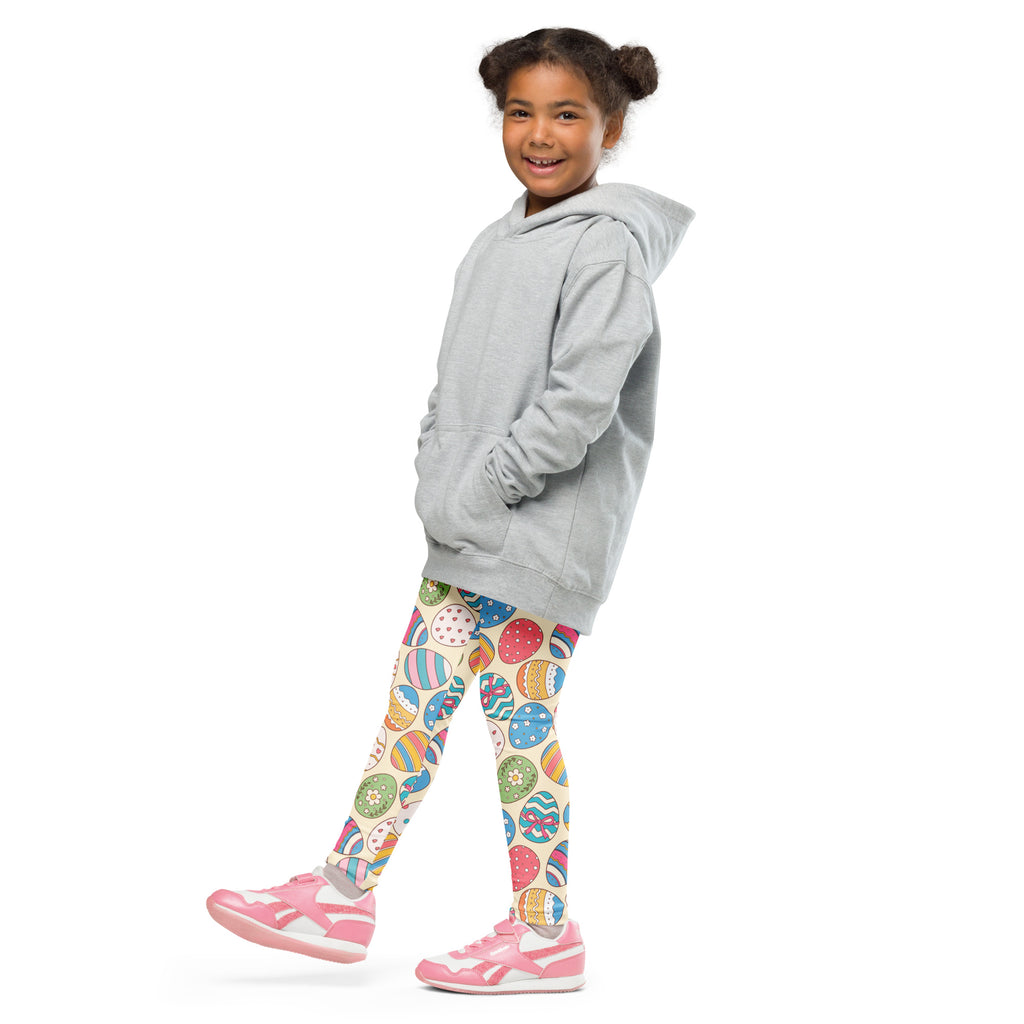 A child wearing girls vintage easter egg buttery soft leggings with colorful egg patterns and a light gray hooded sweatshirt