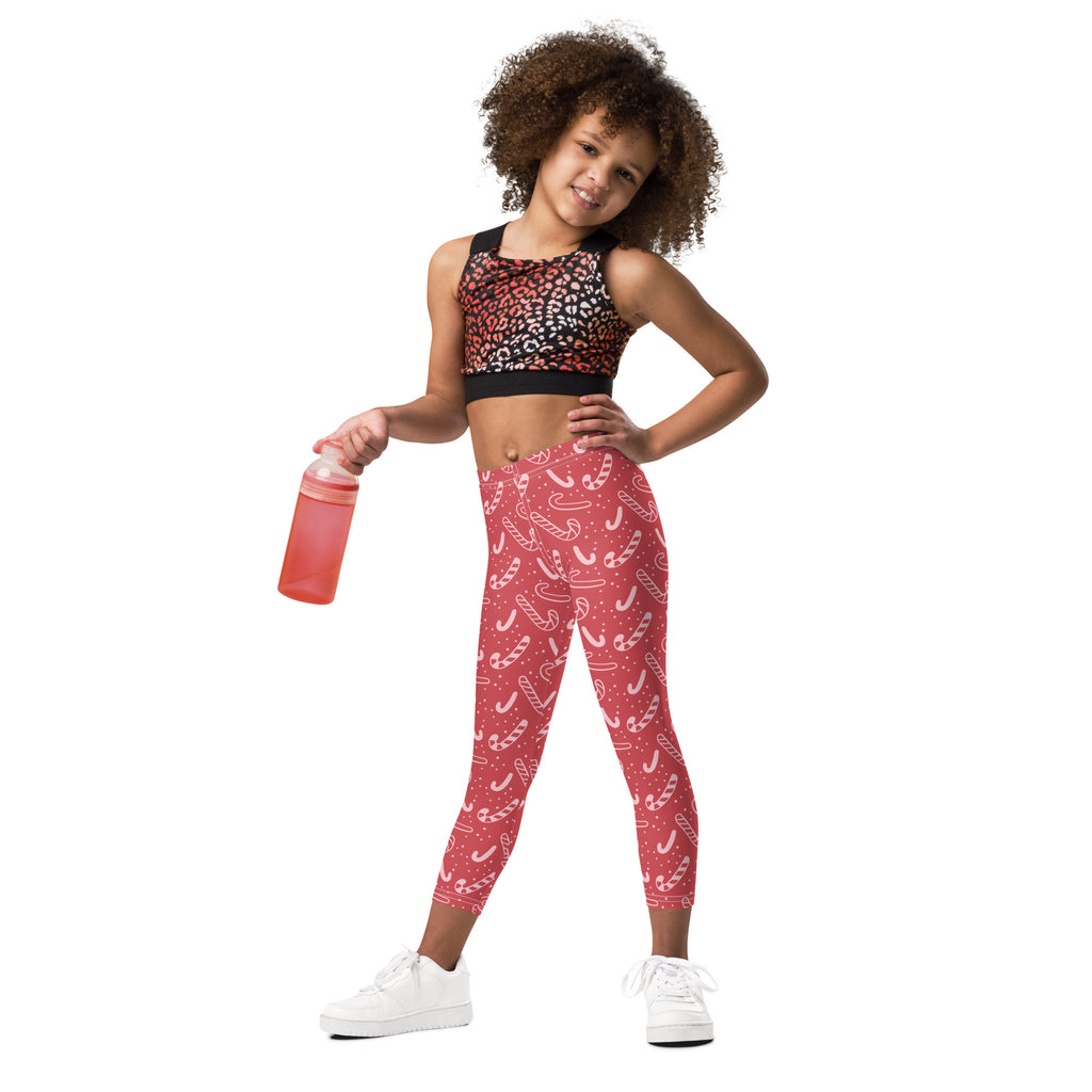 Girls red buttery soft leggings with a white candy cane pattern perfect for festive holiday wear