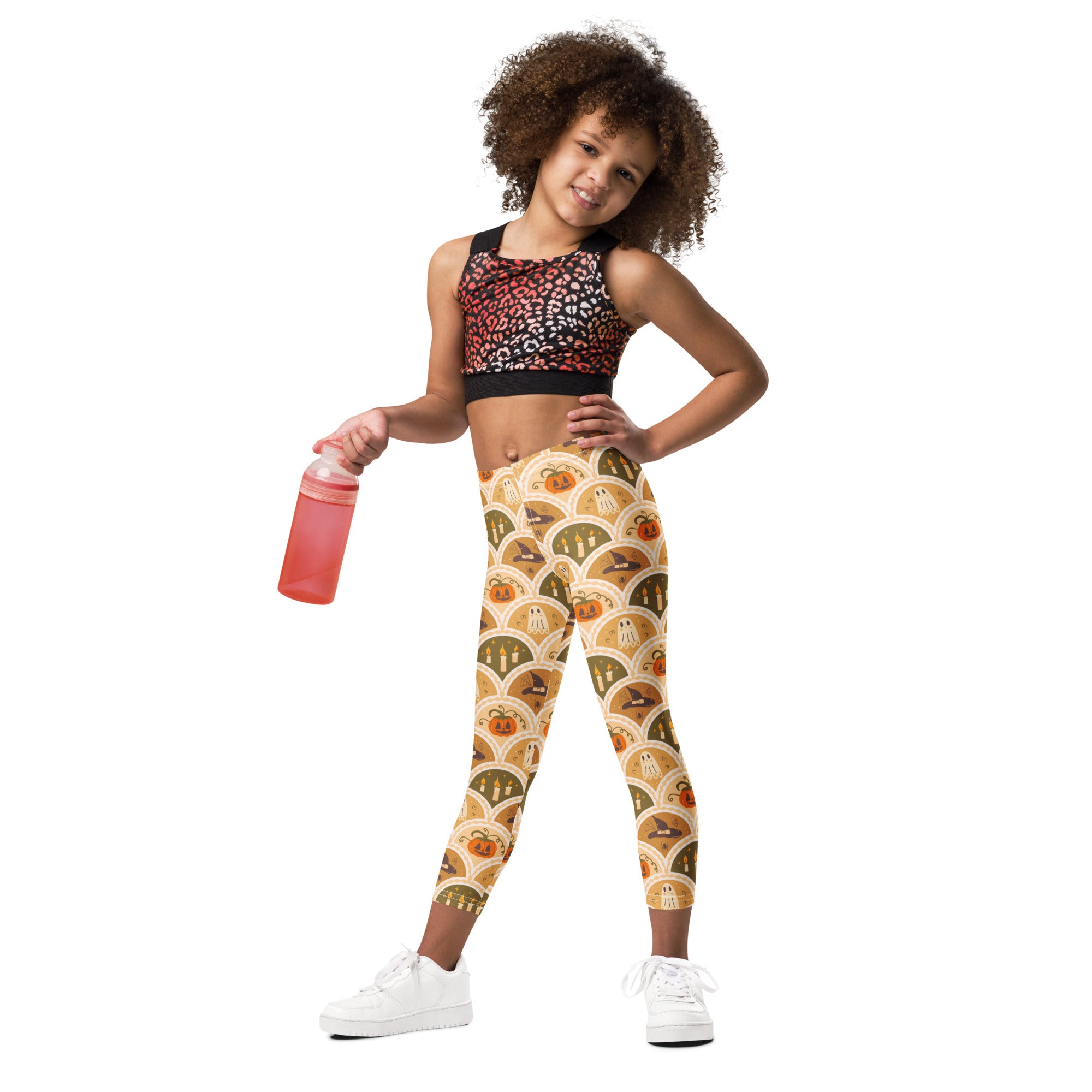 Kids autumn themed halloween buttery soft leggings with pumpkins ghosts and witch hats pattern on beige background