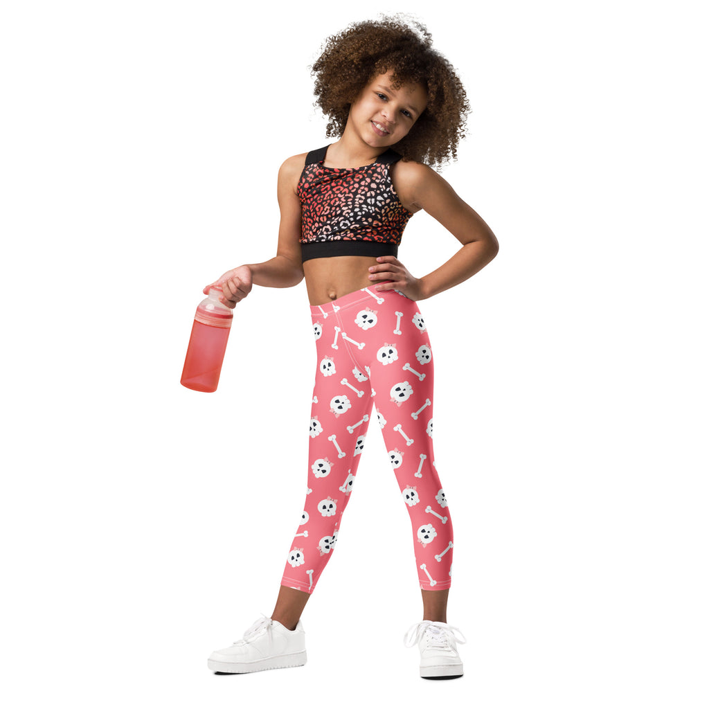 Girls pink buttery soft leggings with a playful white skull and bones pattern perfect for halloween wear