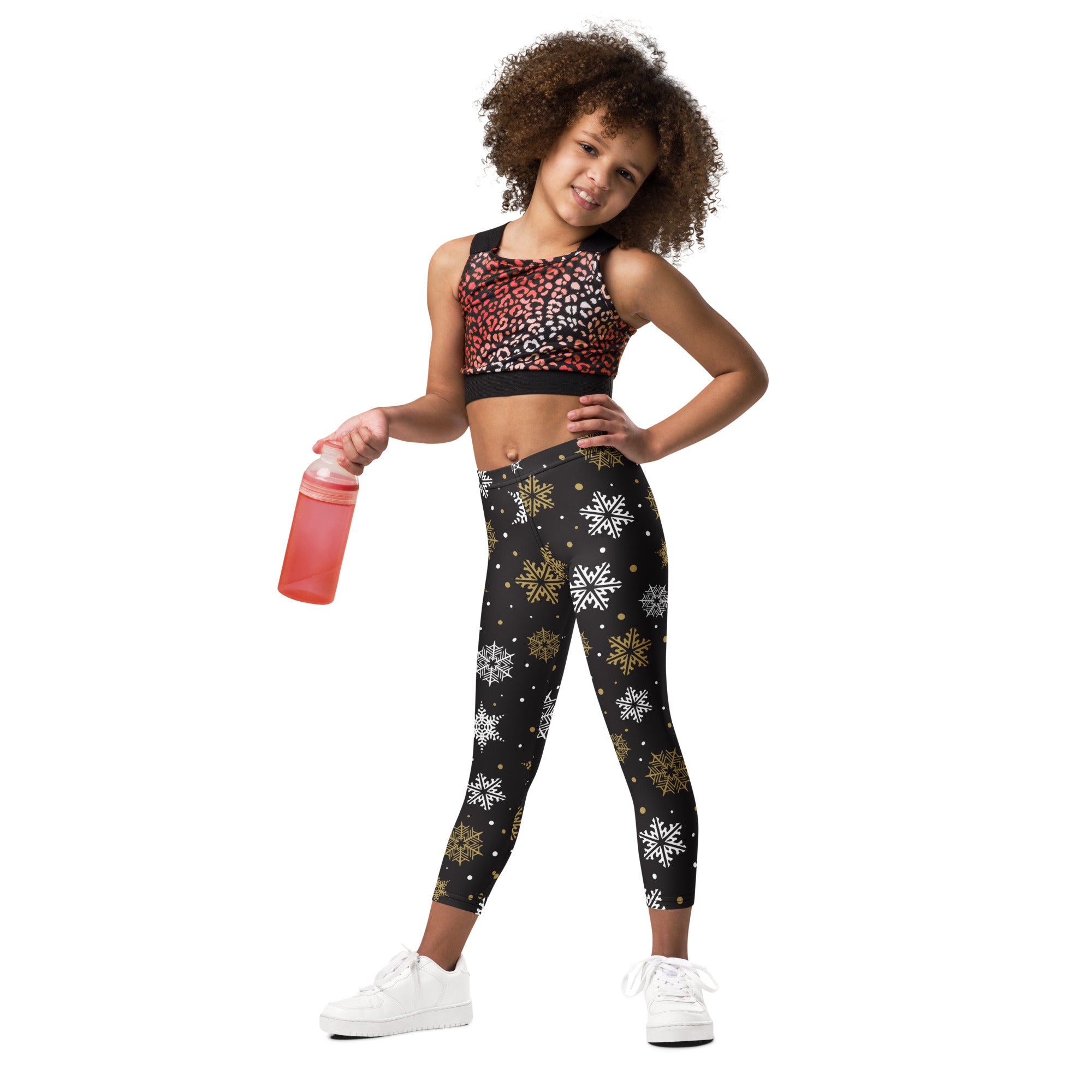 Black kids buttery soft leggings with white and gold festive snowflake pattern perfect for winter wear