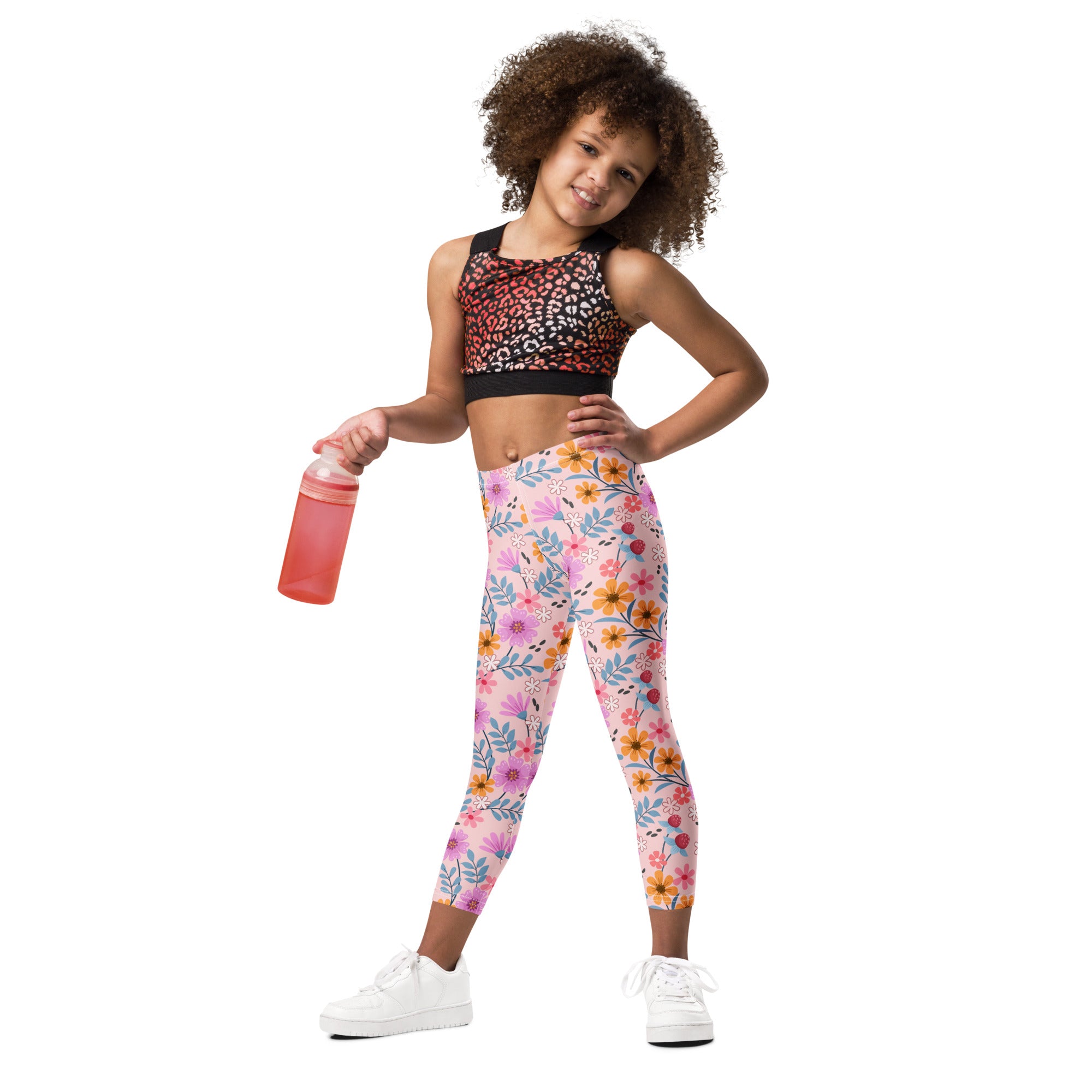 Girls pink floral buttery soft leggings with vibrant pink orange and blue flowers on a light background