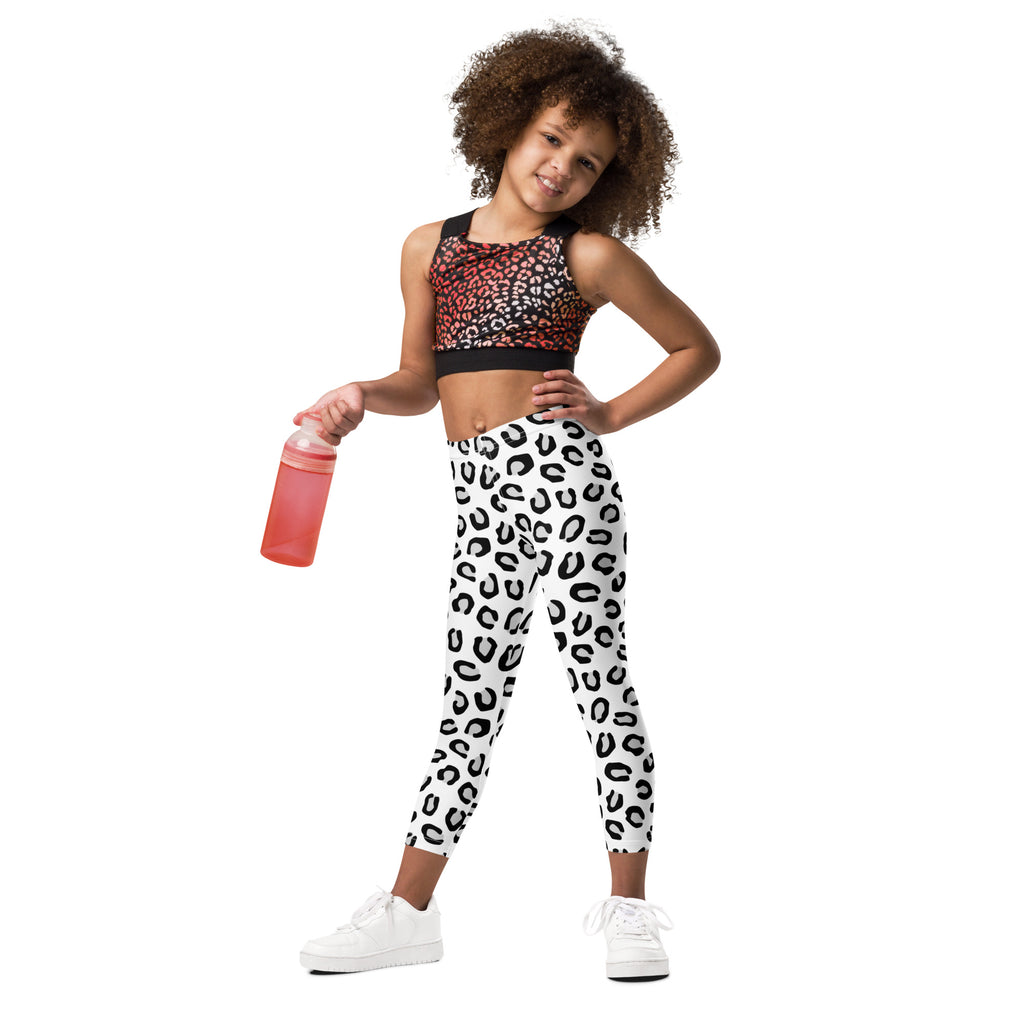 Girls black and white leopard print buttery soft leggings featuring a white base with black leopard spots