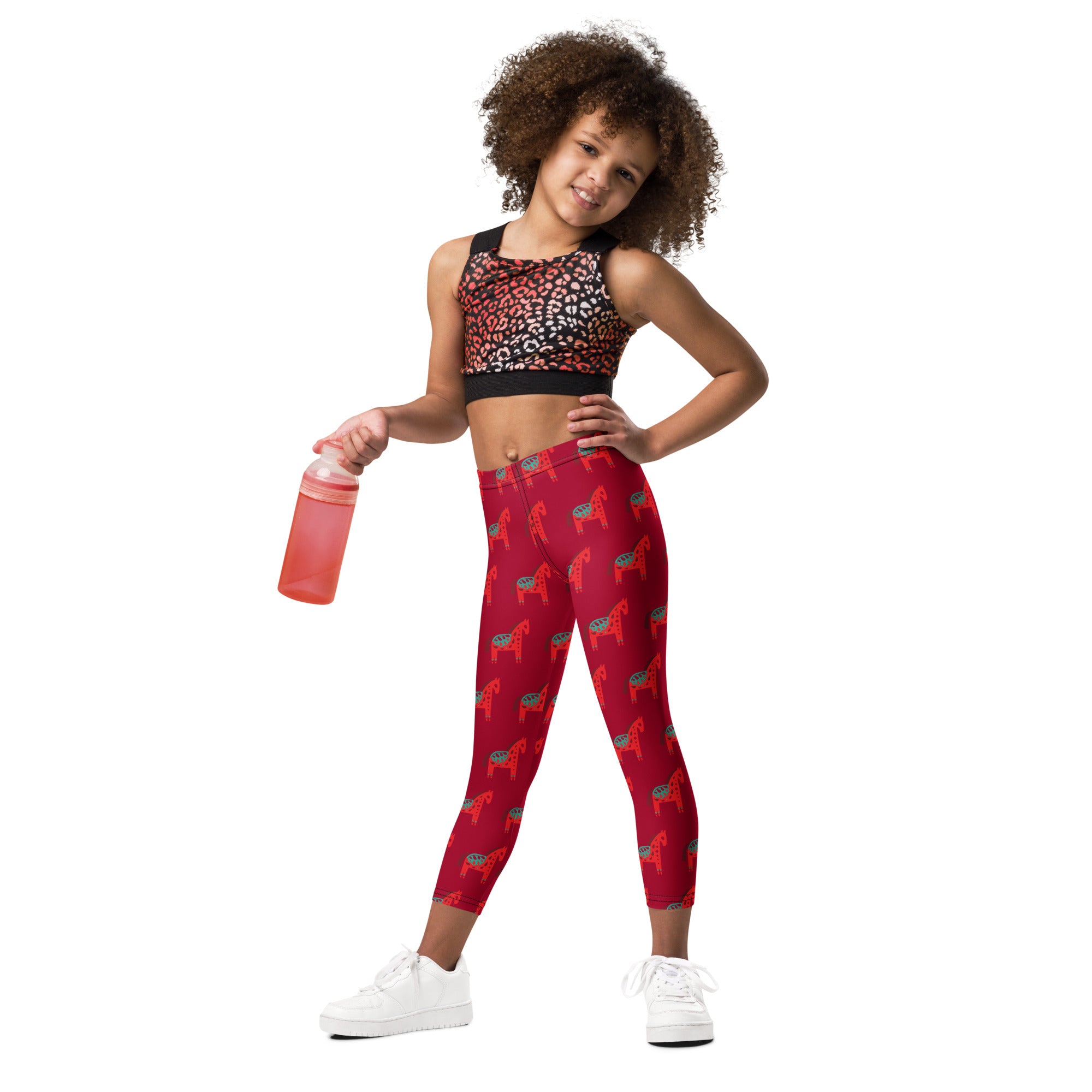 Girls scandi horse christmas buttery soft red leggings with repeating darker red and black dala horse pattern