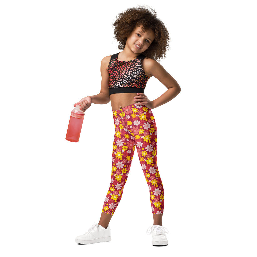 Girls red floral buttery soft leggings in pink and yellow floral pattern paired with a black sports bra top