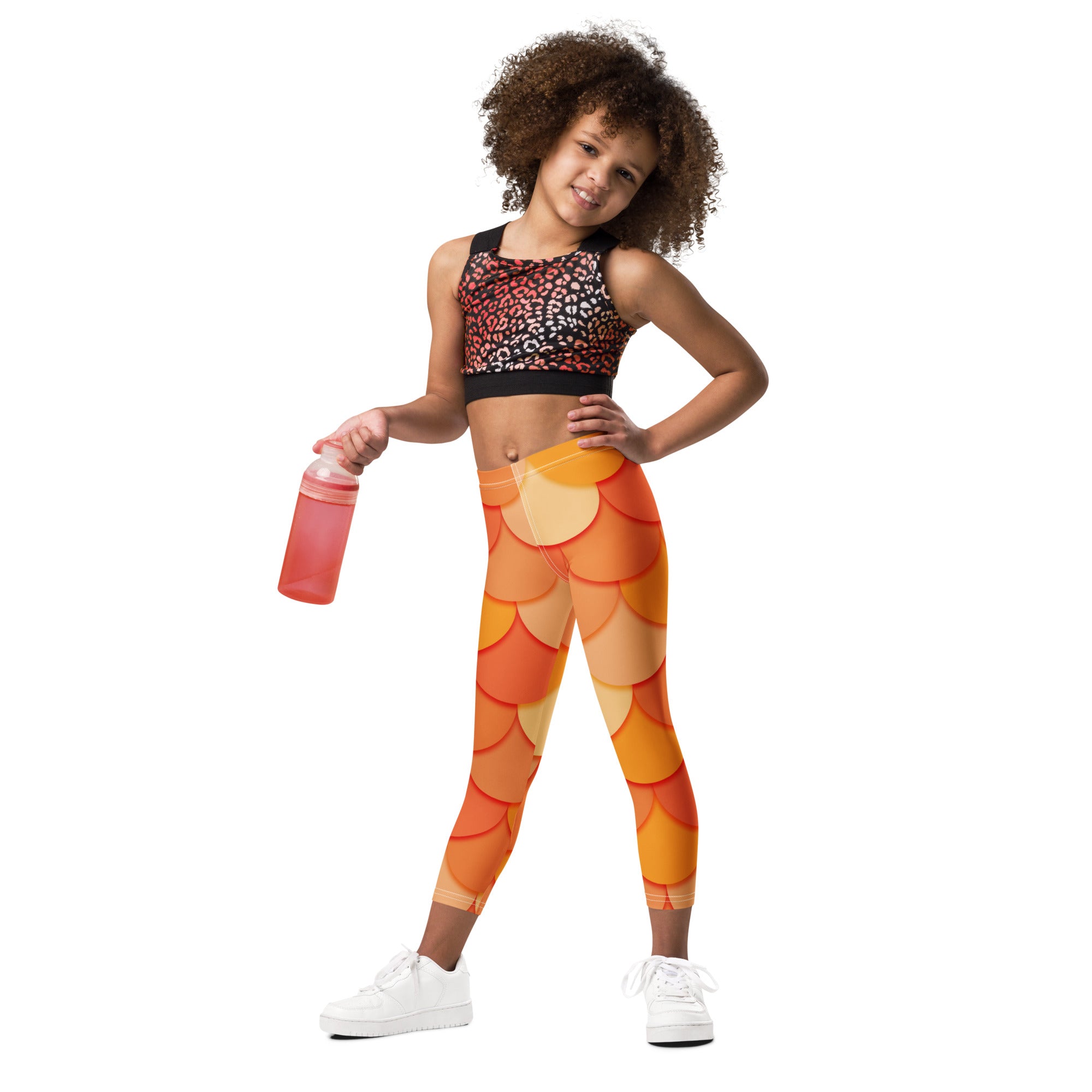 Girls orange mermaid buttery soft leggings in scale pattern paired with a black leopard print crop top