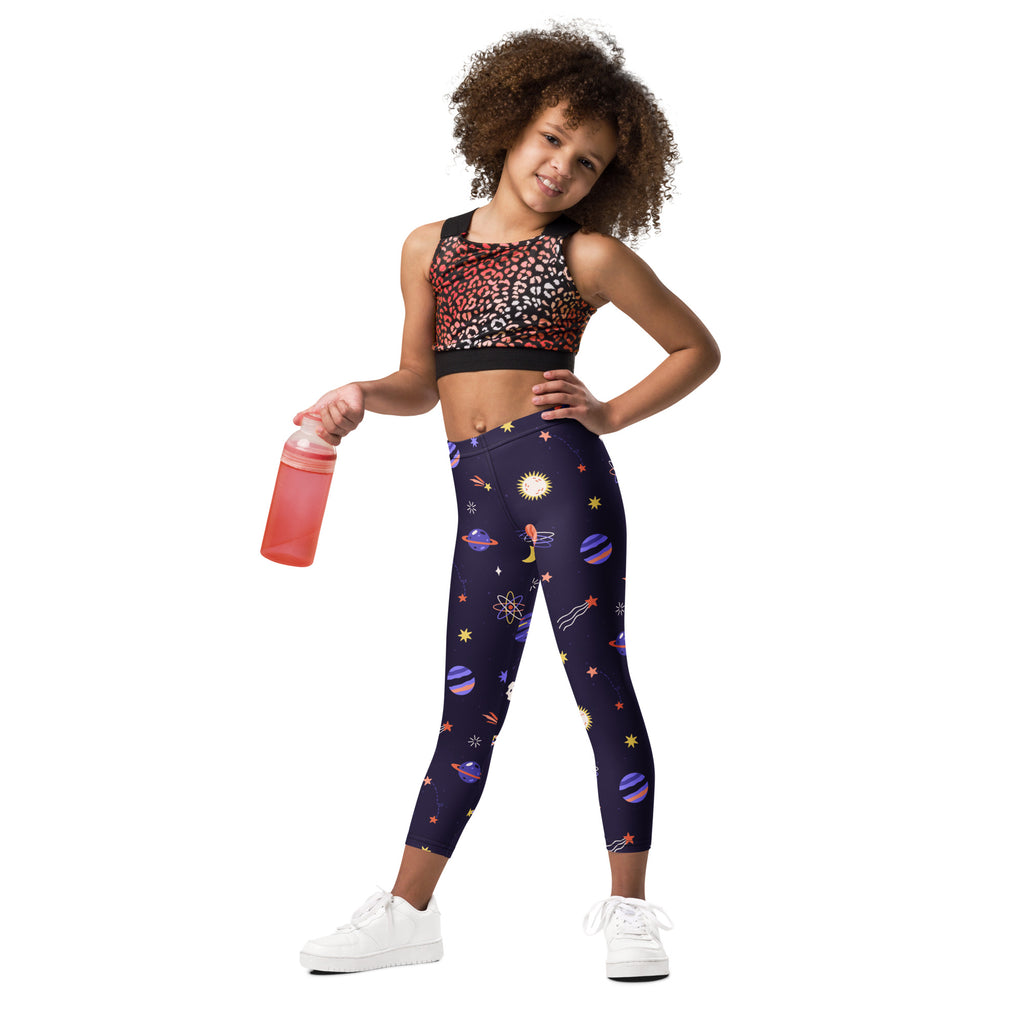 A child wearing girls purple outer space buttery soft leggings with a vibrant space-themed pattern of planets and stars