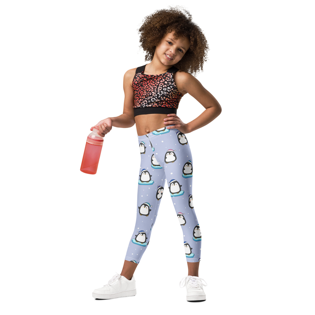 Light blue girls winter penguin christmas buttery soft leggings with playful cartoon penguins on icebergs pattern