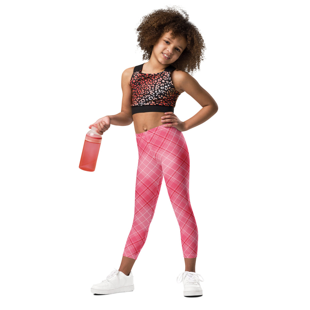 Girls pink plaid buttery soft leggings paired with a black and white leopard print crop top in front view