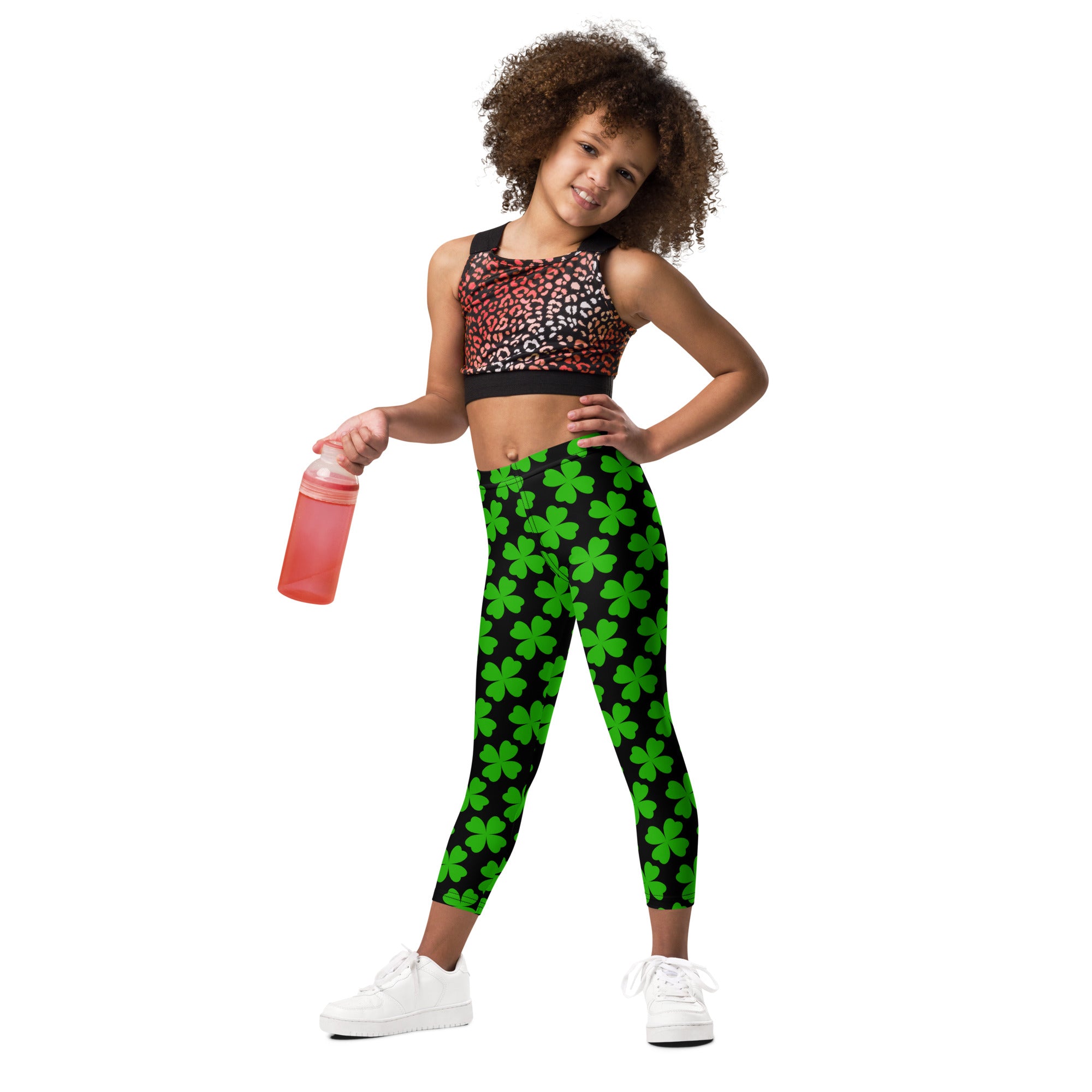 Girls black and green shamrock buttery soft leggings featuring green four-leaf clover pattern on black fabric