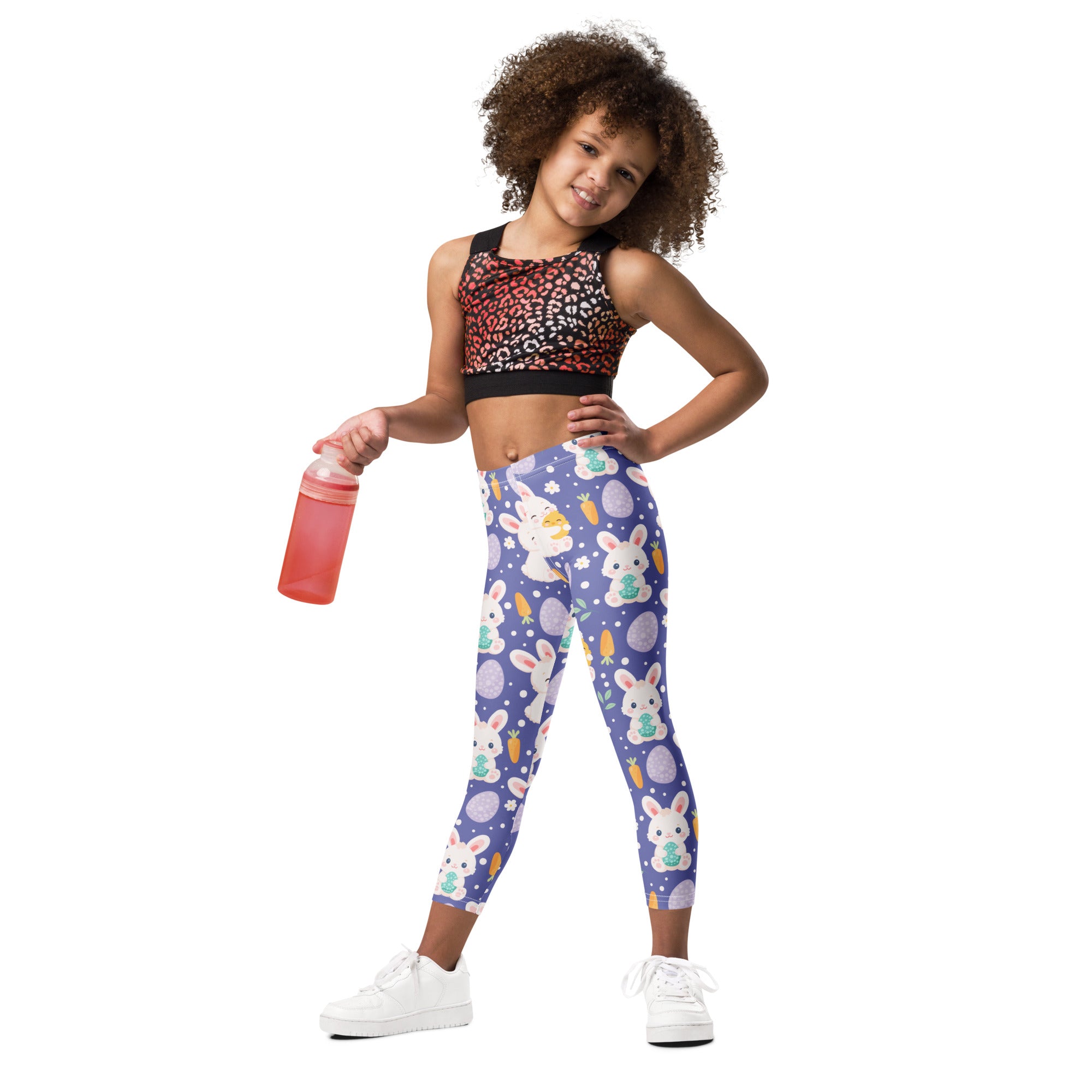 Girls purple buttery soft leggings with a playful easter-themed pattern of white bunnies pastel eggs and carrots