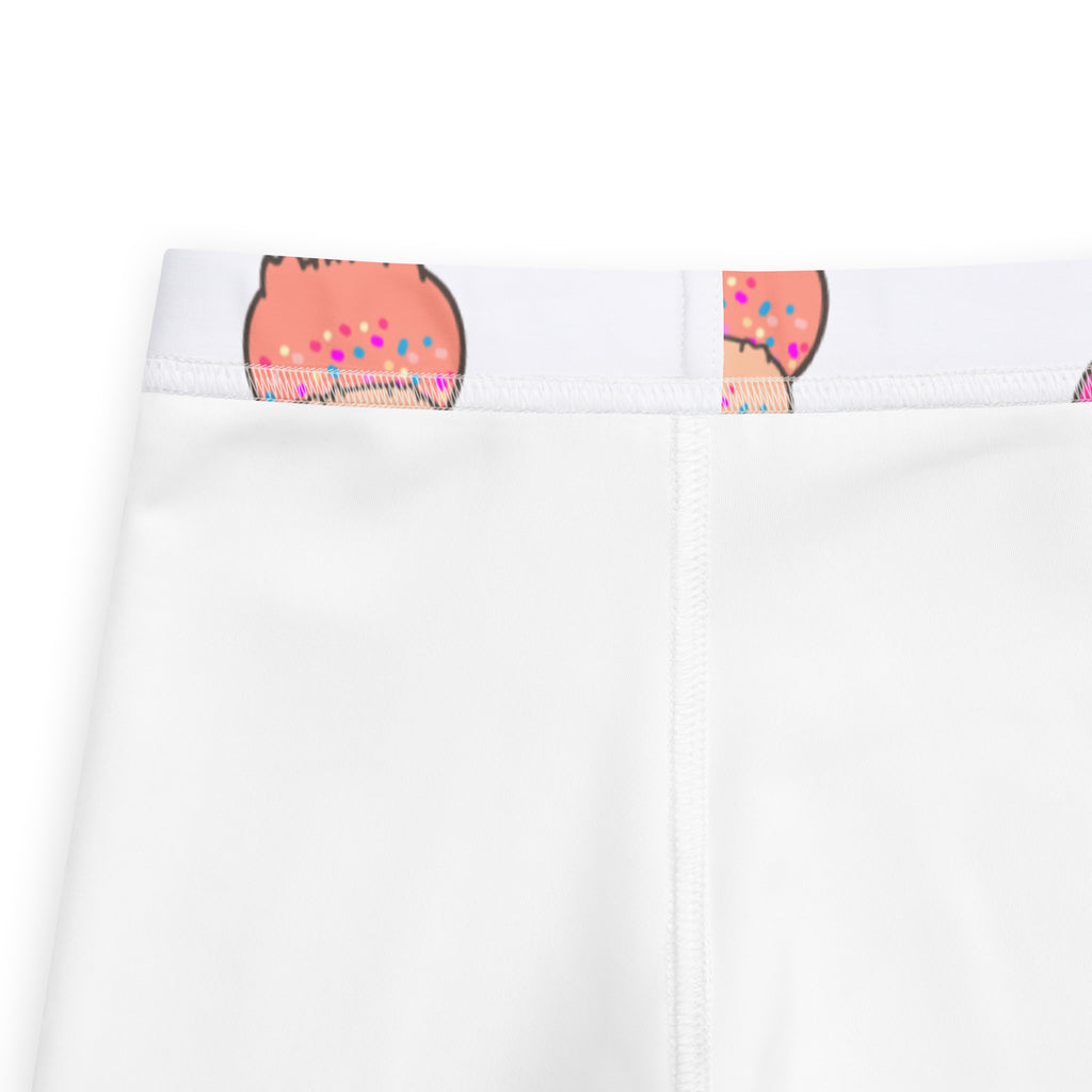 Close-up detail of white kids leggings with pink donut print waistband and colorful sprinkles