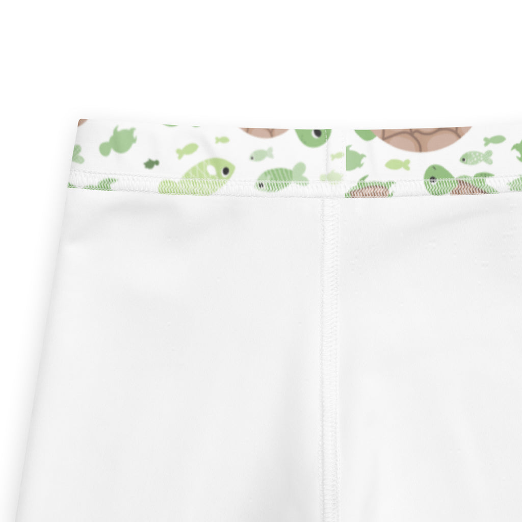 Kids green sea turtles buttery soft white leggings with playful green and brown sea creature pattern on waistband