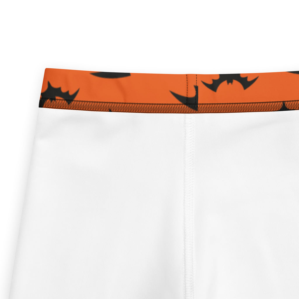 White kids shorts with an orange waistband and black bat silhouettes in buttery soft halloween leggings material