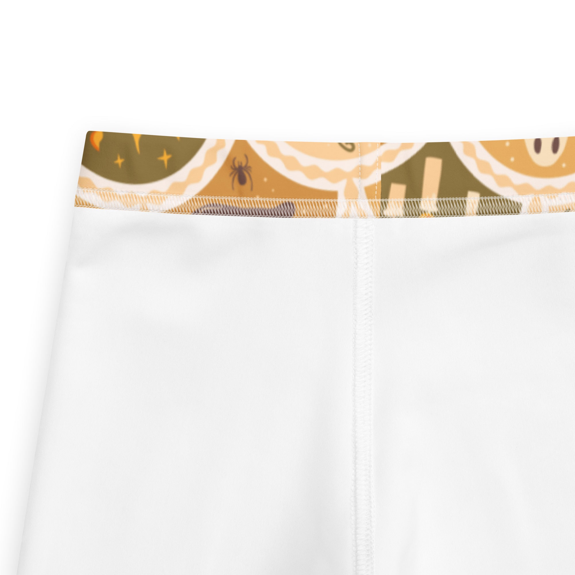 White kids leggings with buttery soft fabric and a whimsical olive green waistband featuring smiling cookies spiders and stars
