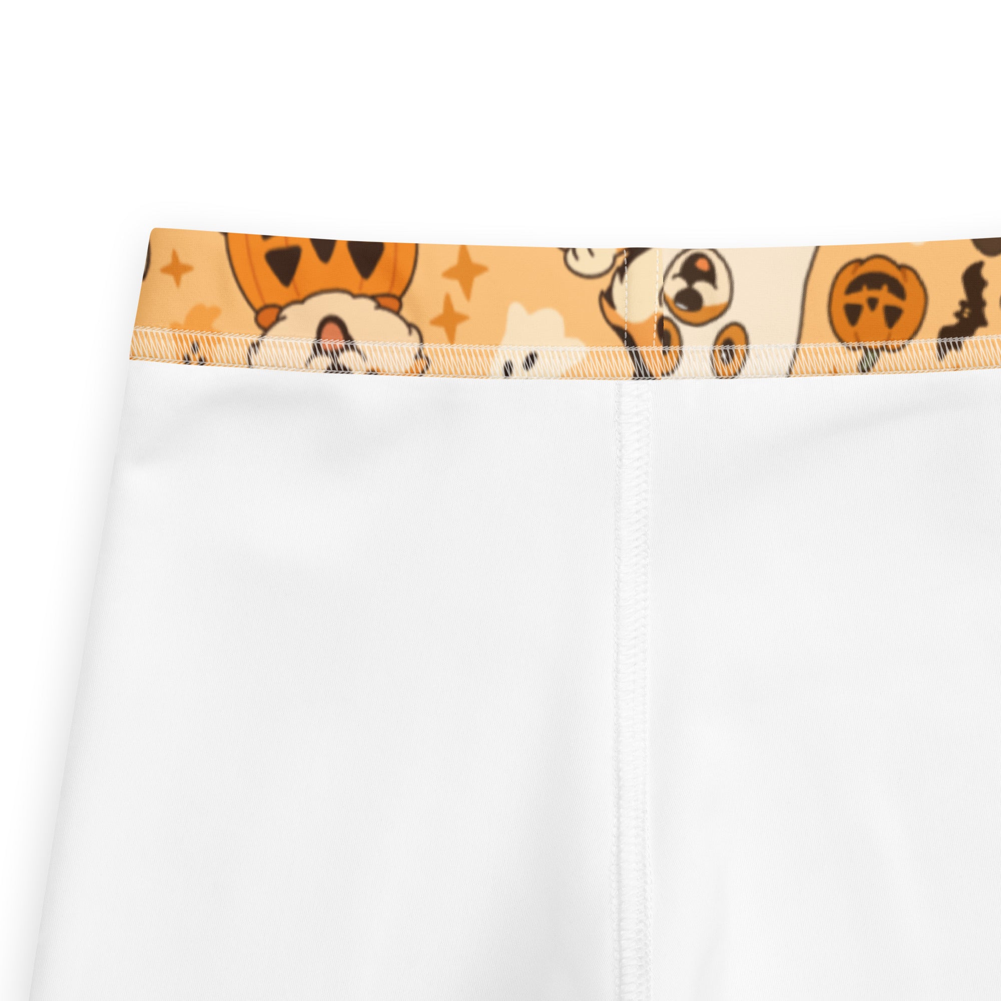 White kids buttery soft leggings with a halloween-themed waistband featuring cartoon pumpkins and corgi dogs