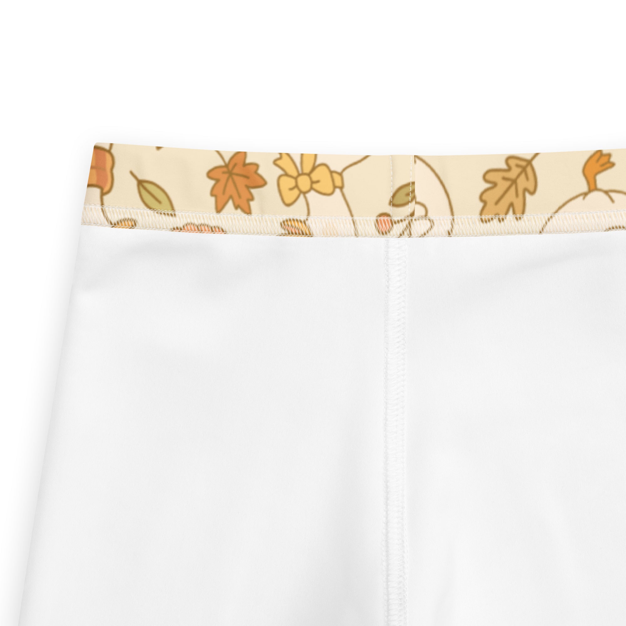 Kids fall goose buttery soft leggings in white fabric with beige waistband featuring autumn leaf and pumpkin patterns
