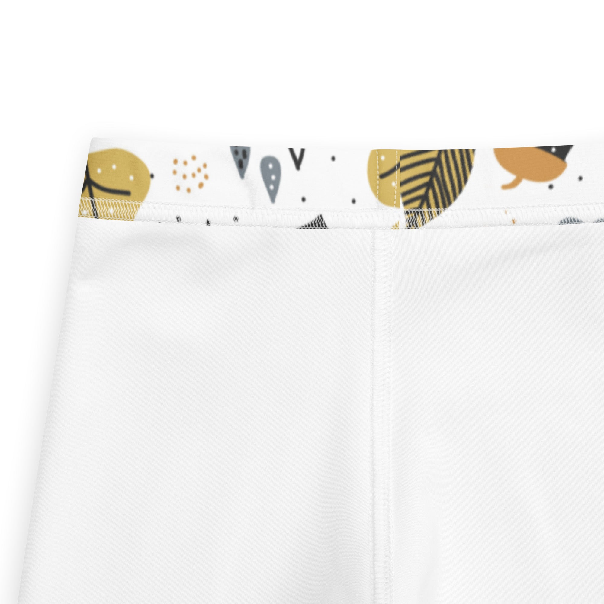 White kids fall season themed buttery soft leggings with decorative gold black and gray abstract leaf waistband