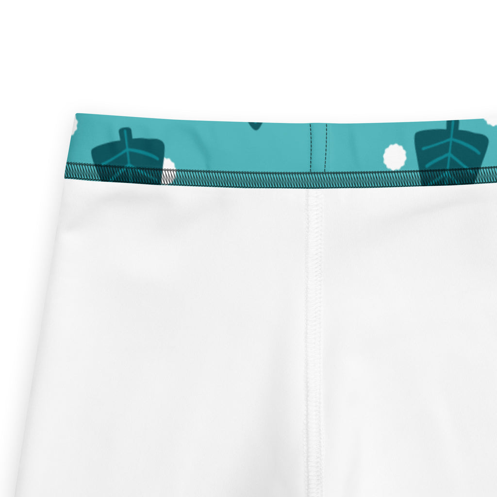 Kids christmas tree snow buttery soft leggings in white with a teal leaf pattern waistband and soft fabric