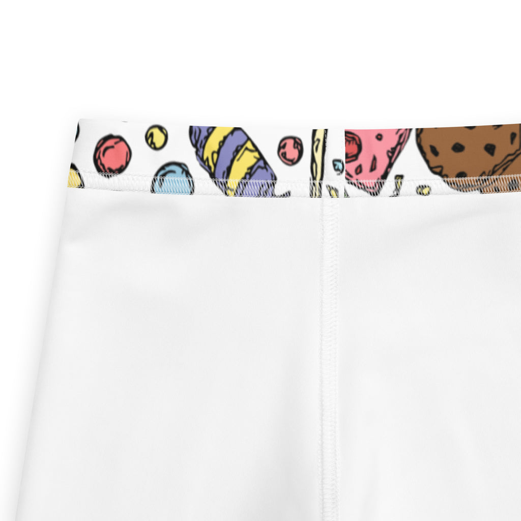 White girls buttery soft leggings with colorful cartoon cookie and candy pattern on the waistband