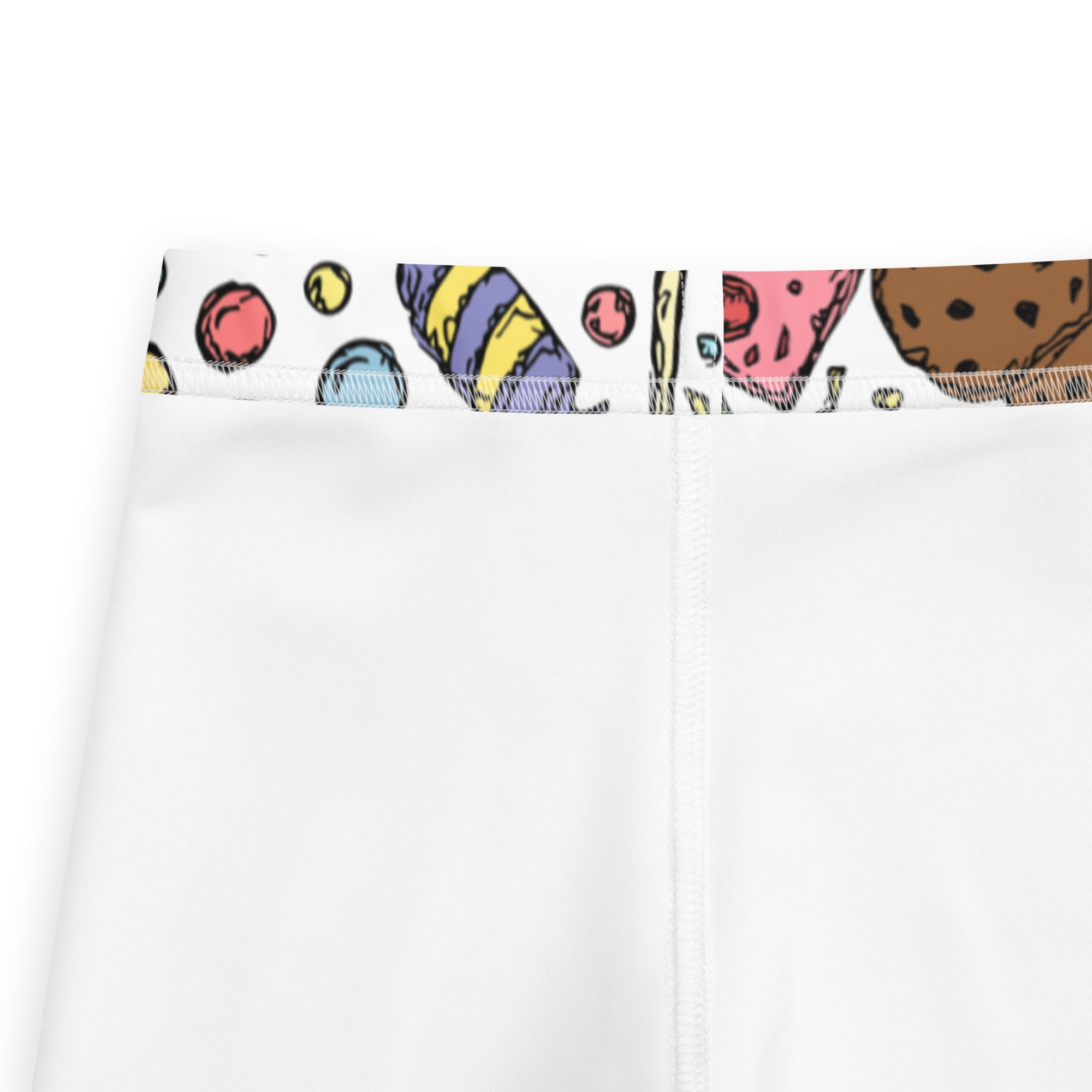 White girls buttery soft leggings with colorful cartoon cookie and candy pattern on the waistband