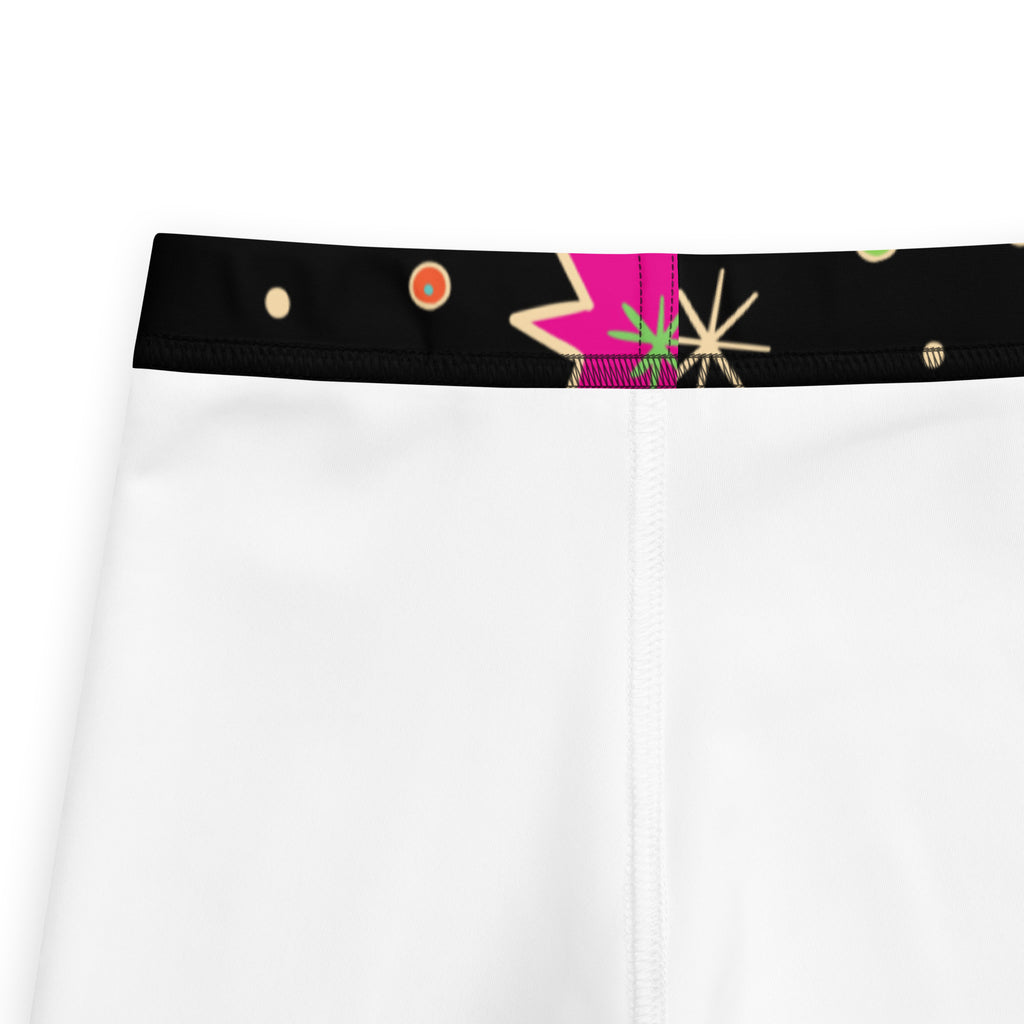 Girls retro outer space buttery soft leggings in white with a black waistband and vibrant pink green beige geometric pattern