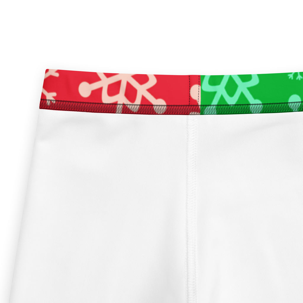 White athletic shorts with a festive red and green snowflake waistband in buttery soft kids leggings style