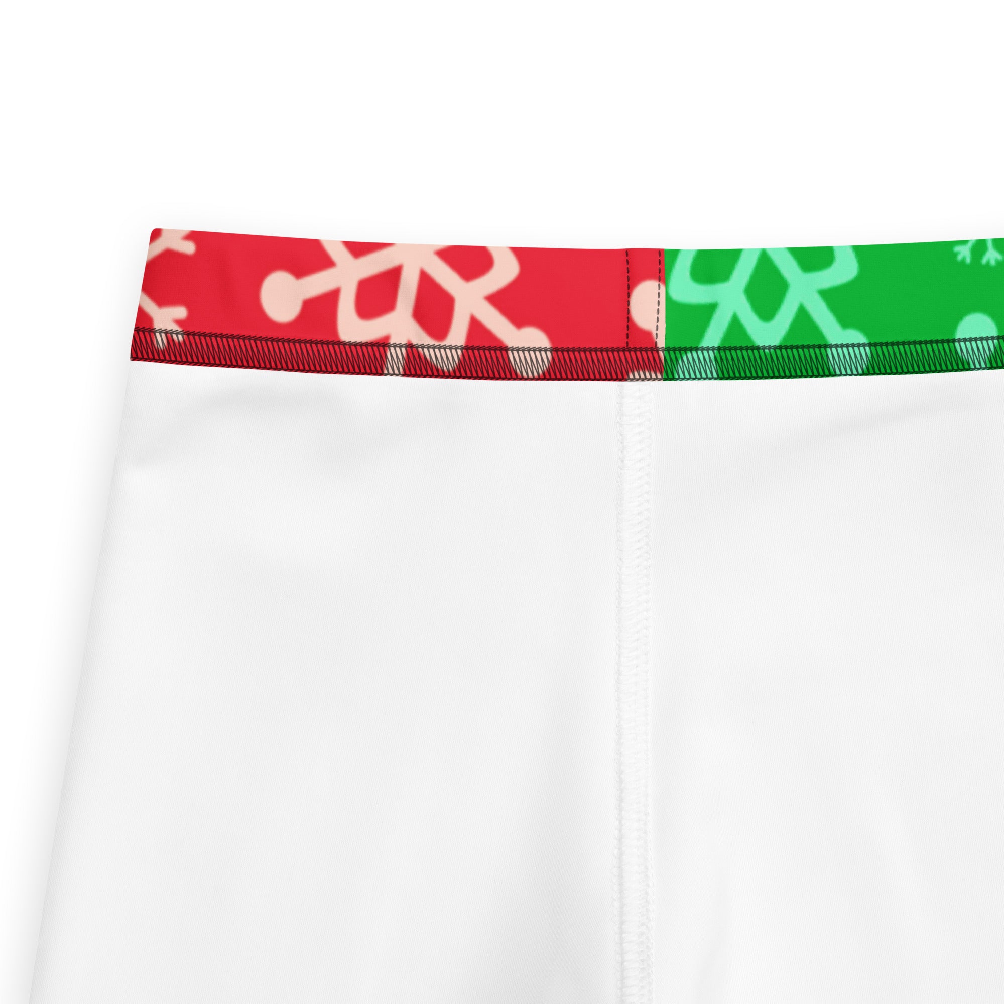 White athletic shorts with a festive red and green snowflake waistband in buttery soft kids leggings style