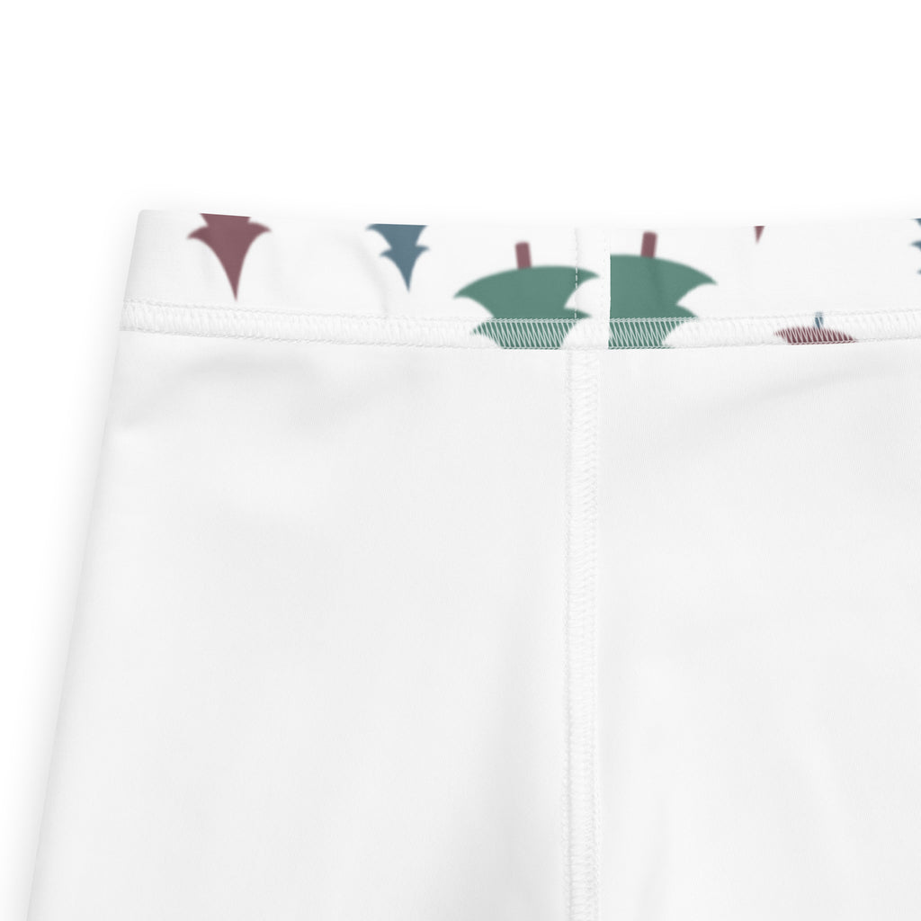 White kids pine tree winter buttery soft leggings with green and maroon stylized trees along the waistband