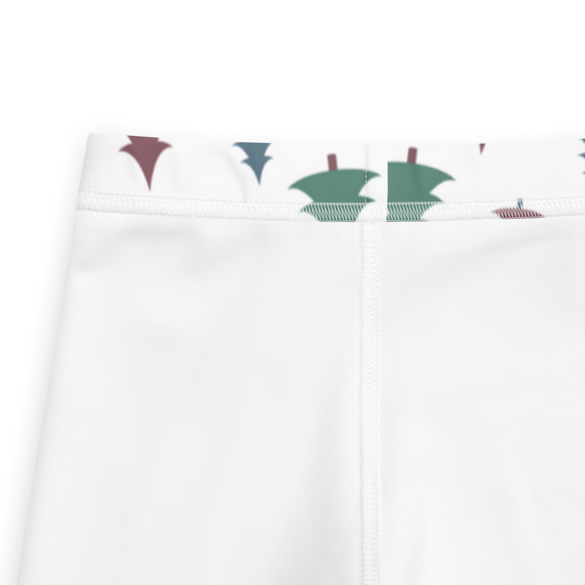 White kids pine tree winter buttery soft leggings with green and maroon stylized trees along the waistband