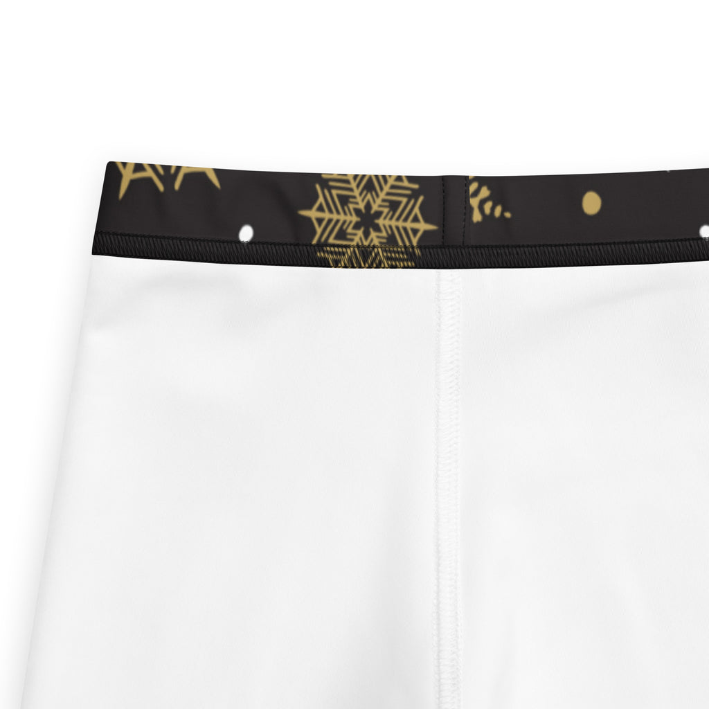 Kids gold and white snowflake buttery soft leggings with white shorts and black waistband featuring gold snowflake patterns