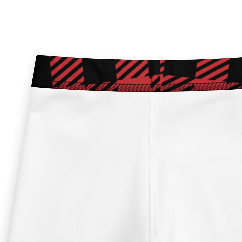 White athletic shorts with bold red and black diagonal stripe waistband paired with kids red buffalo plaid buttery soft leggings