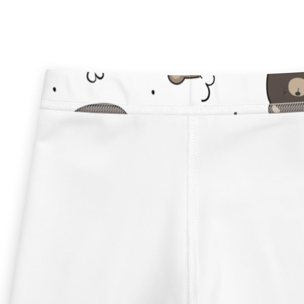 Kids white buttery soft leggings with a cartoon bear face pattern on the waistband visible on the back side