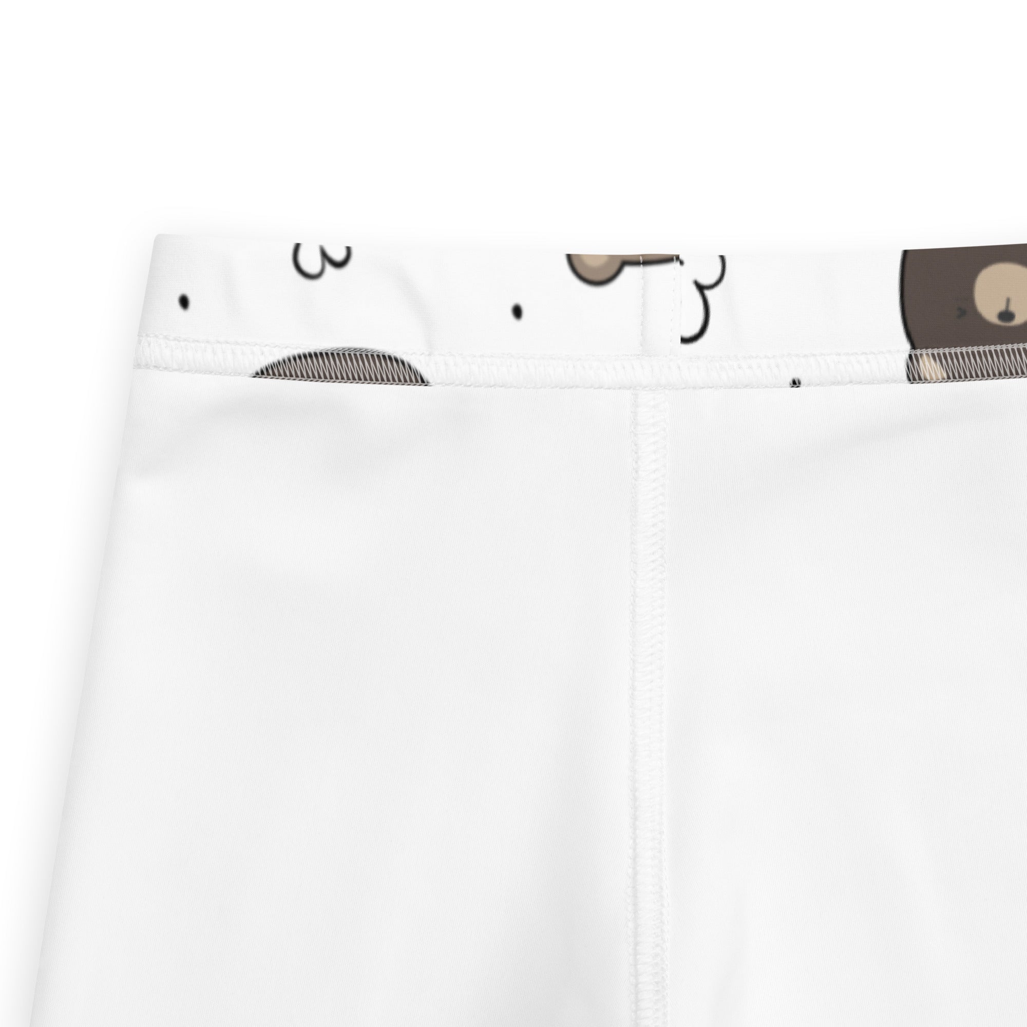 Kids white buttery soft leggings with a cartoon bear face pattern on the waistband visible on the back side