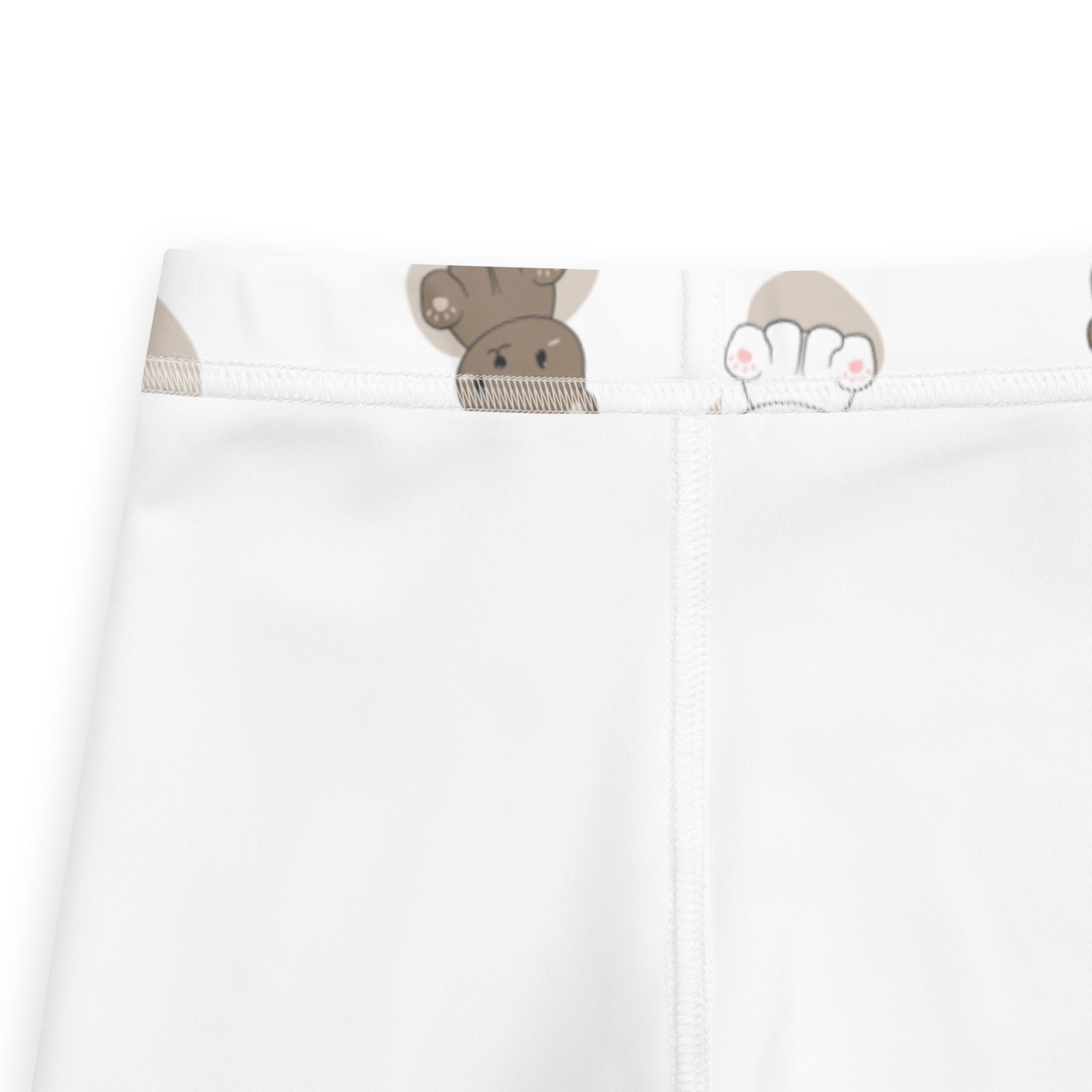 White buttery soft kids leggings featuring a playful pattern of cartoon brown and white bear faces at the waistband