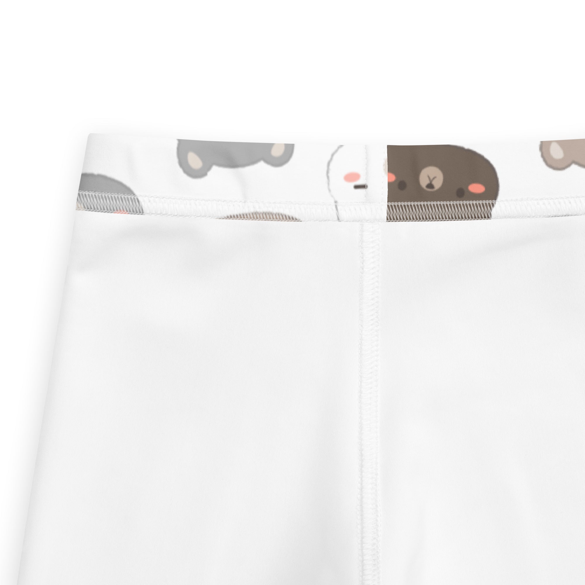 White buttery soft kids leggings with playful cartoon bear face pattern on the waistband