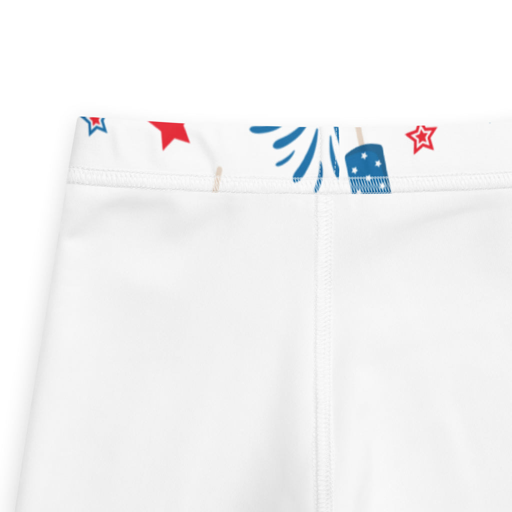 White kids leggings with buttery soft fabric featuring a festive red and blue star and firework waistband design