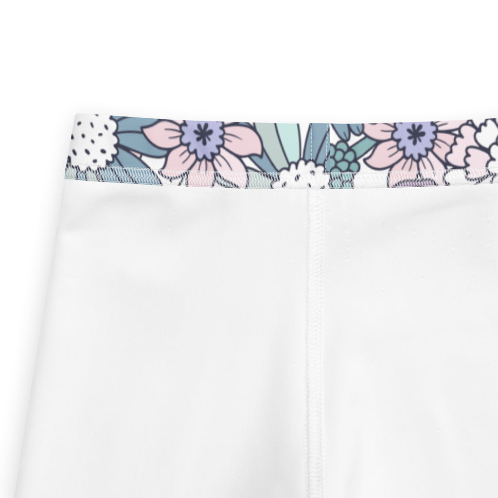 Girls pastel purple floral buttery soft leggings with white pants and a decorative pastel pink lavender teal waistband