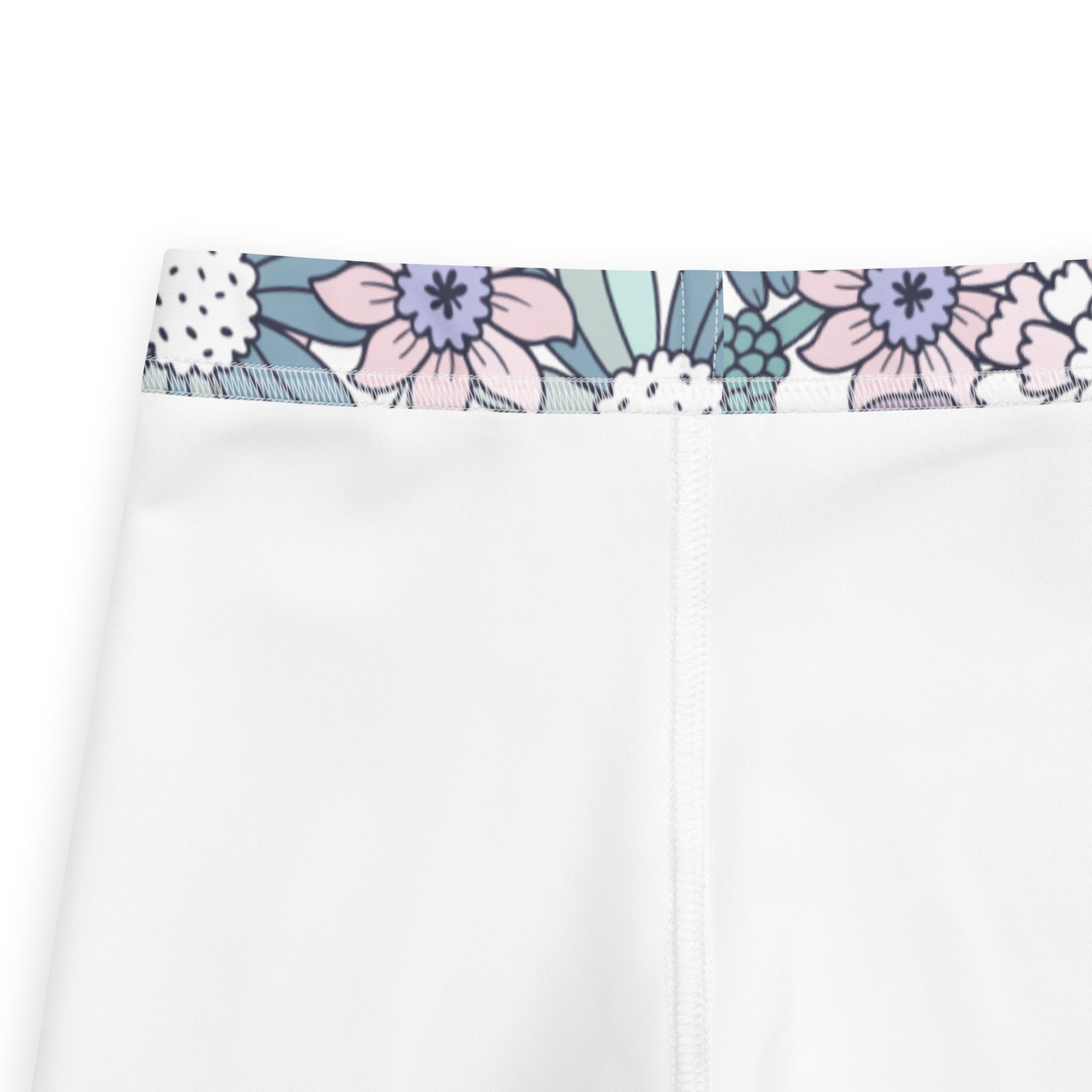 Girls pastel purple floral buttery soft leggings with white pants and a decorative pastel pink lavender teal waistband