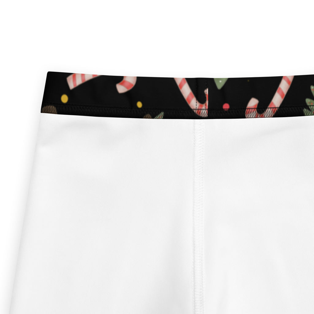 White kids Christmas candy canes and trees buttery soft leggings with black waistband and red and white candy cane patterns