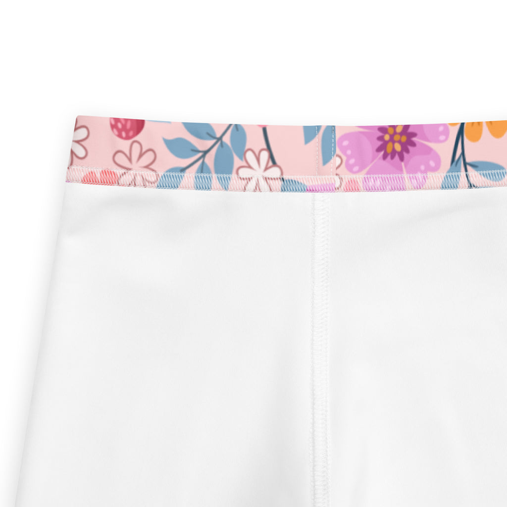 Girls pink floral buttery soft leggings in white with a colorful pink purple and blue floral waistband
