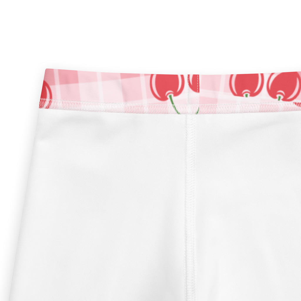 White girls cherry plaid buttery soft leggings with a pink and white checkered waistband and red cherry prints