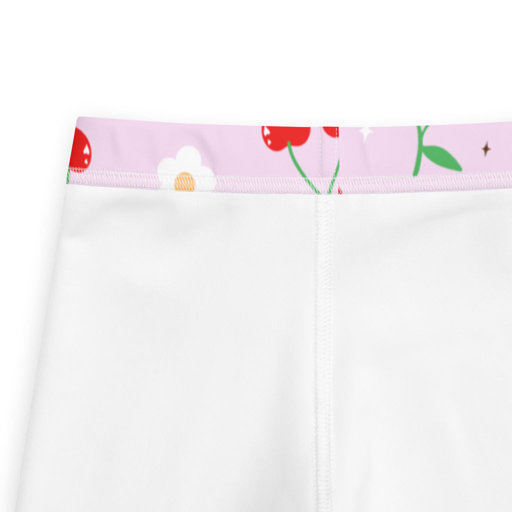 Girls pink cherry buttery soft white leggings with a pink waistband and playful cherry and daisy pattern
