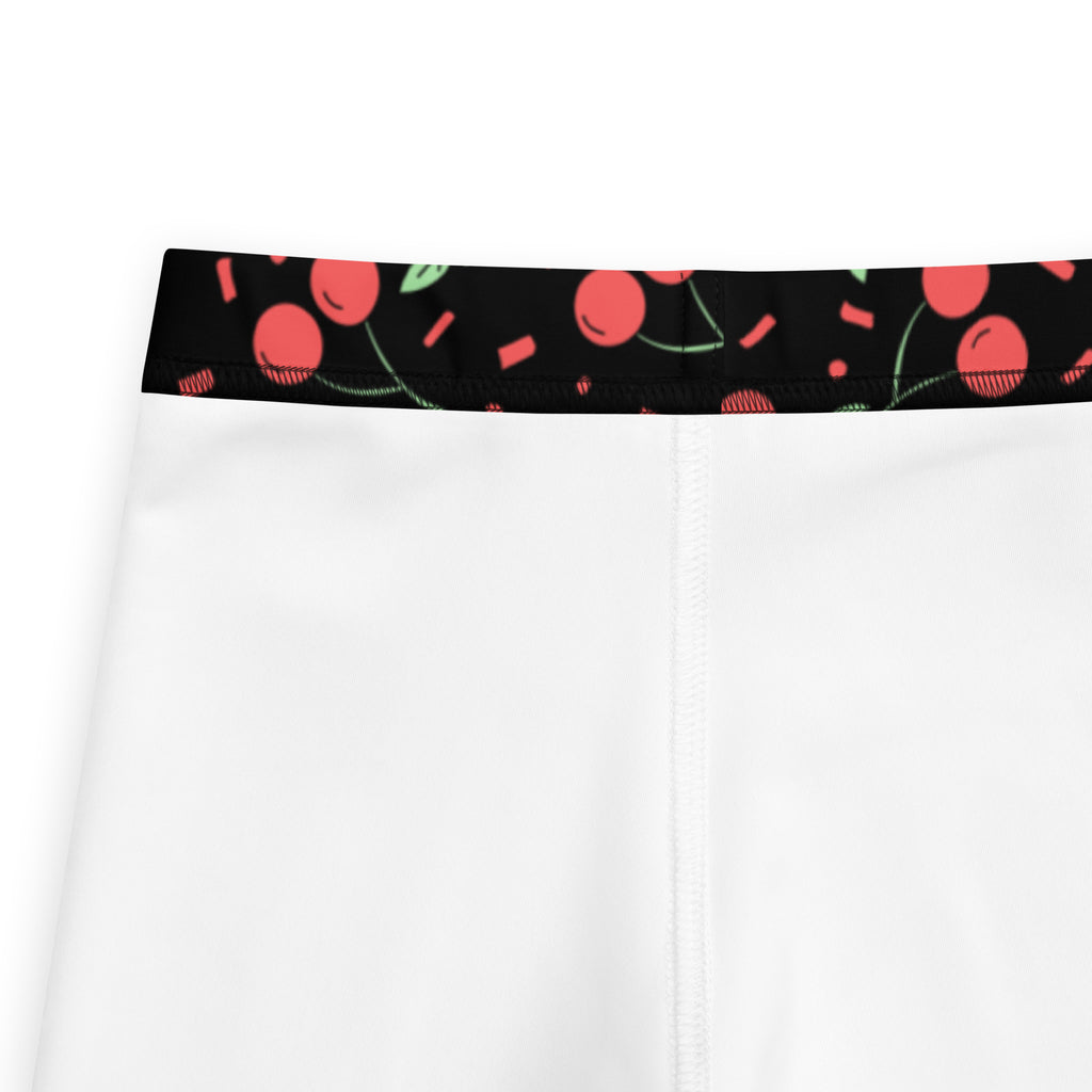 Girls black cherry confetti buttery soft white leggings with black waistband featuring playful pink and green pattern