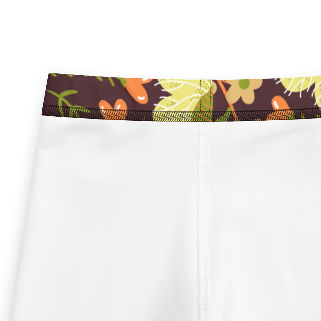 Girls brown floral buttery soft leggings in white with a brown waistband and colorful cartoon floral and vegetable pattern