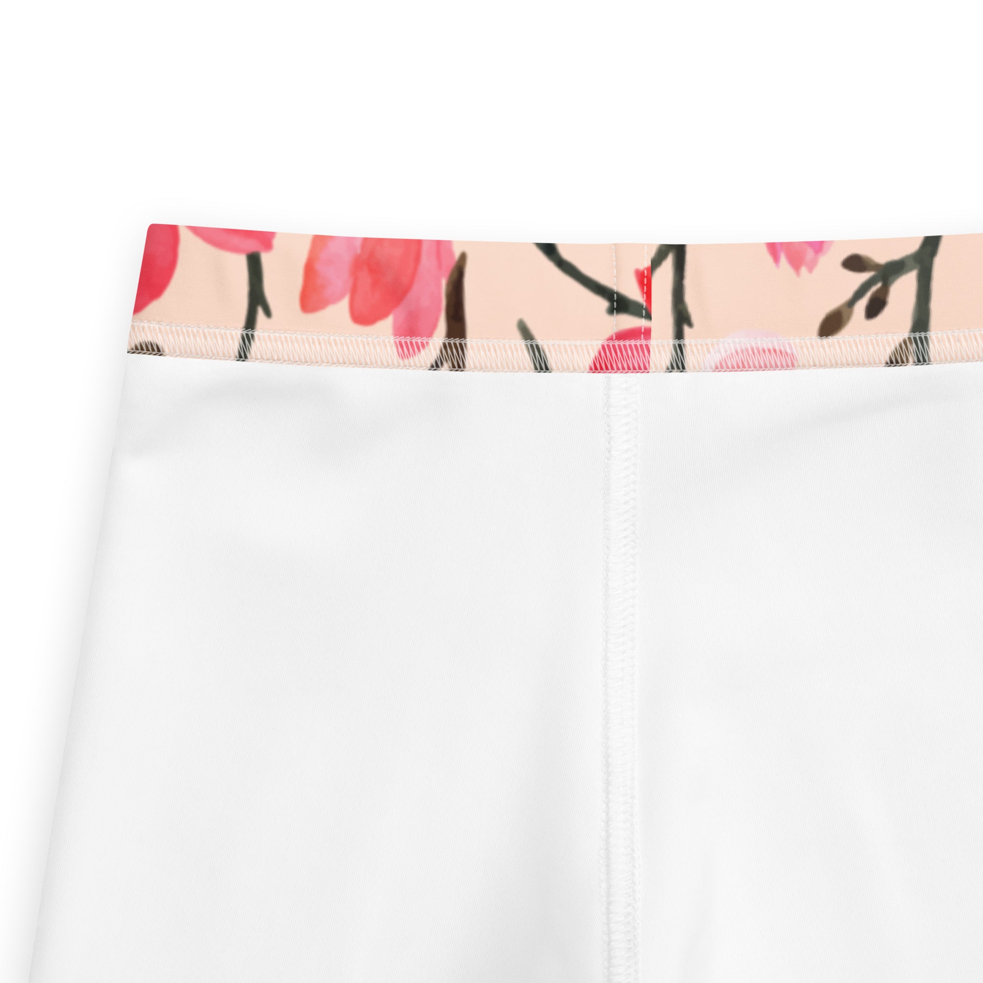 White girls leggings with pink and black floral patterned waistband made of buttery soft fabric