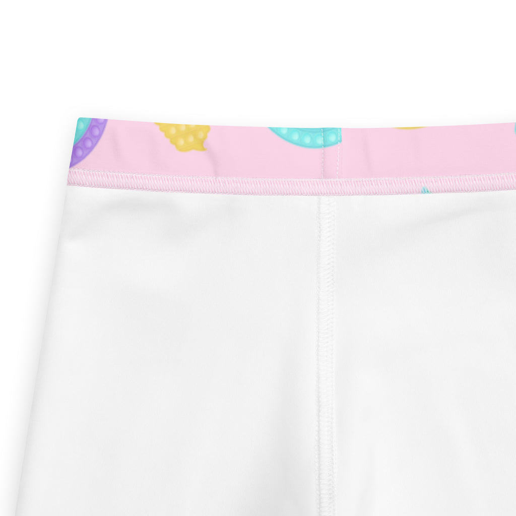 Girls fidget toy themed white leggings with a pink waistband and colorful polka-dotted donut patterns in buttery soft fabric